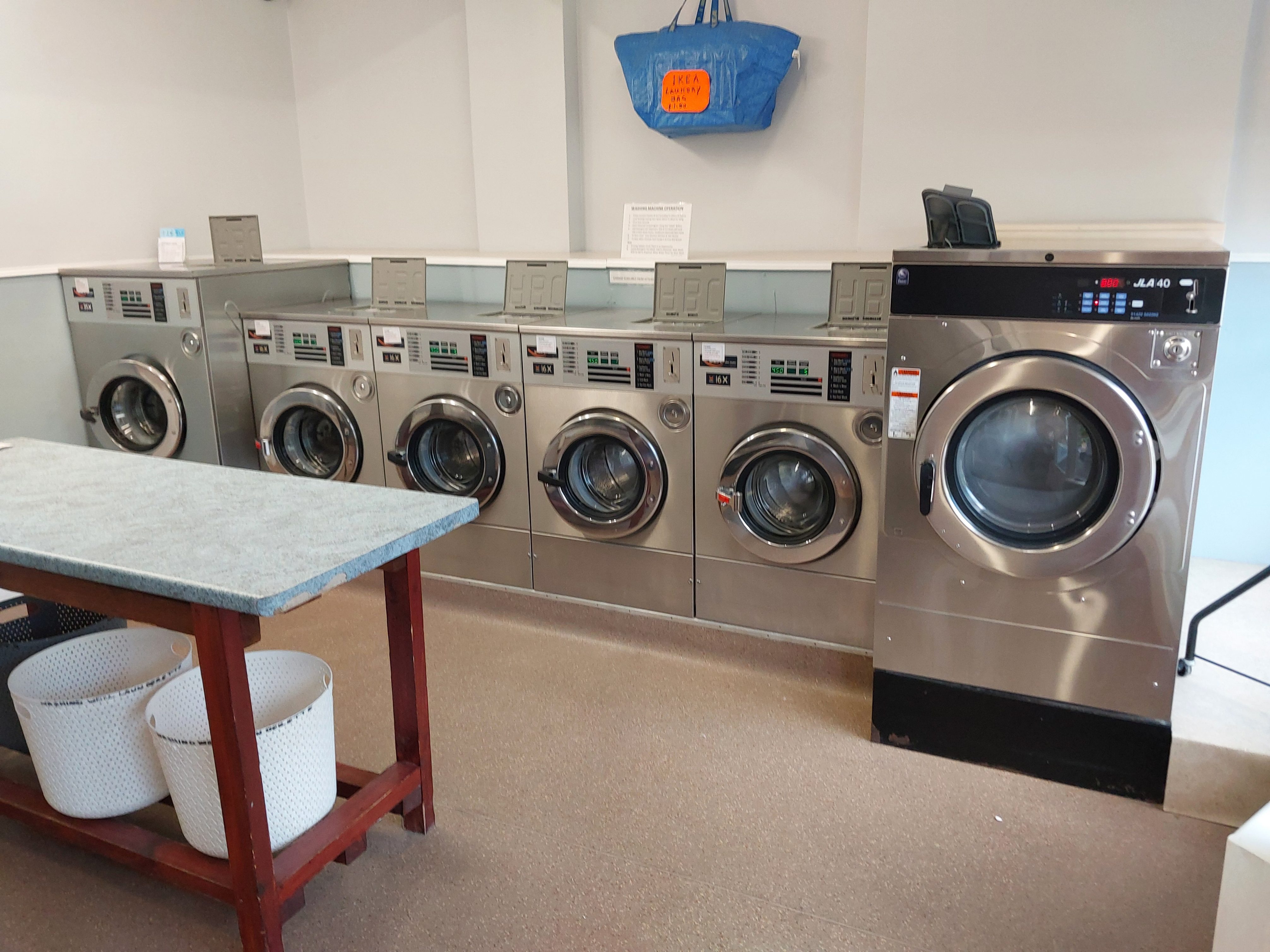 Rows of high-capacity washing machines at Washing Well Launderette Paignton